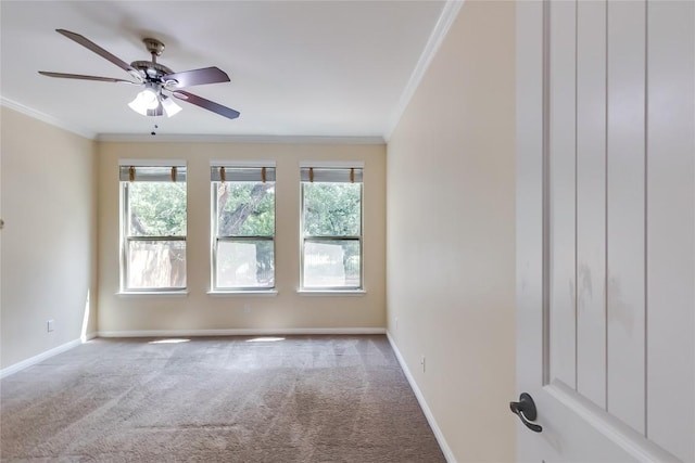 spare room featuring a healthy amount of sunlight, ornamental molding, and carpet