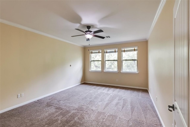 empty room featuring crown molding, ceiling fan, carpet floors, and baseboards