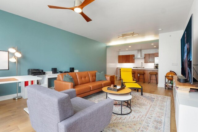 living area featuring ceiling fan and light wood-style flooring