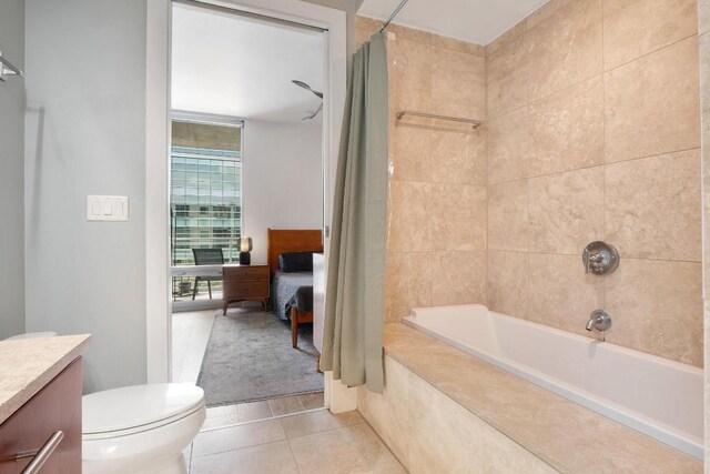 full bathroom with tile patterned floors, vanity, shower / bathtub combination with curtain, and toilet