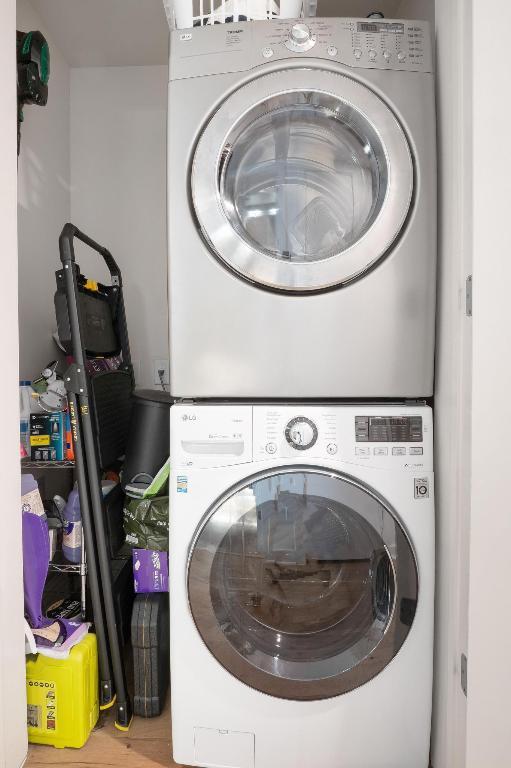 laundry room featuring stacked washing maching and dryer and laundry area