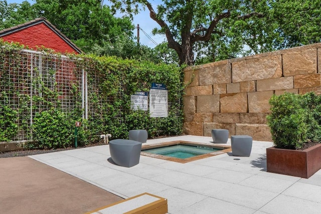 view of swimming pool featuring fence, a patio, and a hot tub