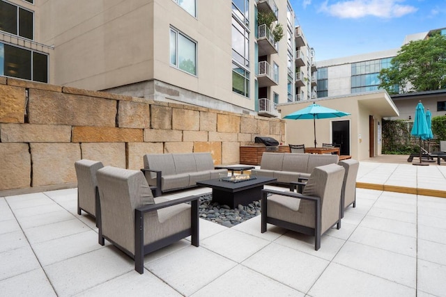 view of patio featuring a grill and an outdoor living space with a fire pit