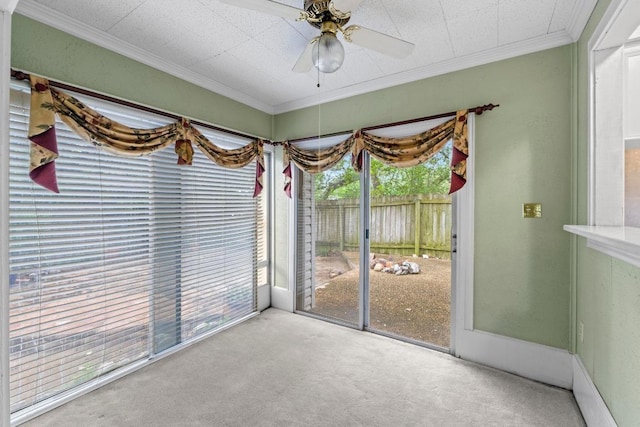 unfurnished sunroom with a ceiling fan