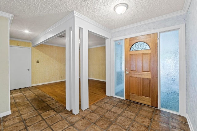 foyer entrance featuring crown molding, stone finish flooring, a textured ceiling, and baseboards