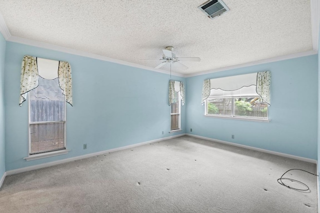 carpeted spare room featuring visible vents, ornamental molding, a textured ceiling, and a ceiling fan