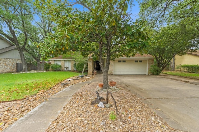 obstructed view of property with a front yard and concrete driveway