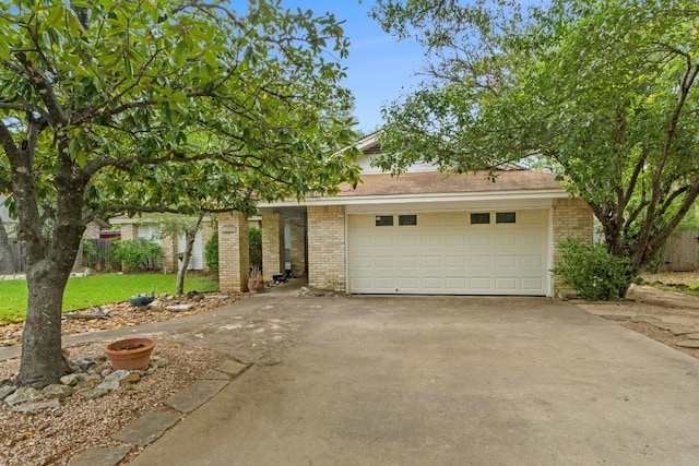 view of front of property with brick siding, a garage, a front lawn, and aphalt driveway
