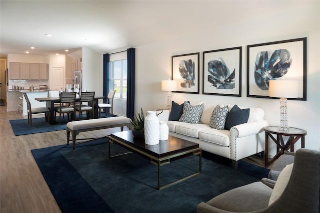 living area with recessed lighting and light wood finished floors