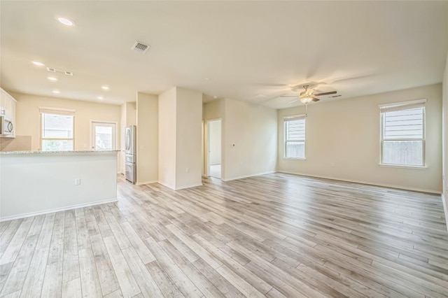 10401 American Paint Way, Manor, TX 78653 - unfurnished living room with ceiling fan, light wood-style floors, baseboards, and recessed lighting