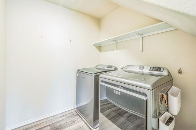 10401 American Paint Way, Manor, TX 78653 - laundry area featuring washing machine and dryer and light wood-style flooring