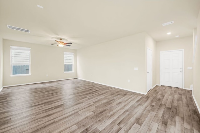 10401 American Paint Way, Manor, TX 78653 - empty room with wood finished floors, a ceiling fan, and baseboards