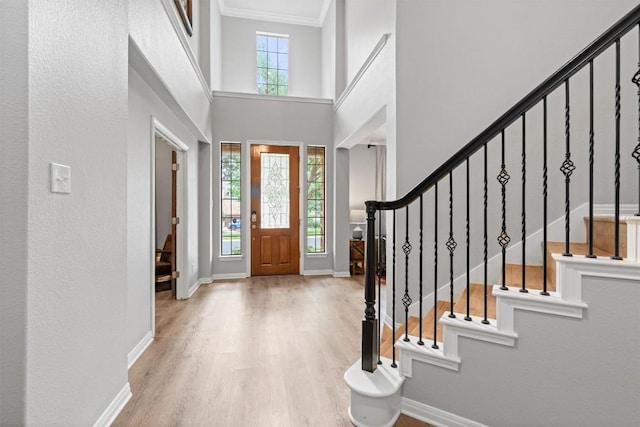 3912 Walsh Ranch Blvd, Round Rock, TX 78681 - foyer featuring wood finished floors, stairway, ornamental molding, and a high ceiling