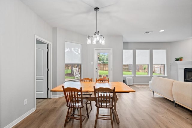 3912 Walsh Ranch Blvd, Round Rock, TX 78681 - dining space with wood finished floors, a glass covered fireplace, and recessed lighting