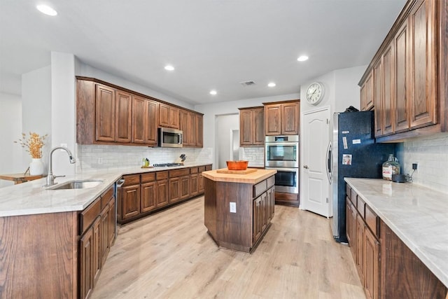 3912 Walsh Ranch Blvd, Round Rock, TX 78681 - kitchen featuring stainless steel appliances, tasteful backsplash, light wood-style floors, butcher block counters, and recessed lighting
