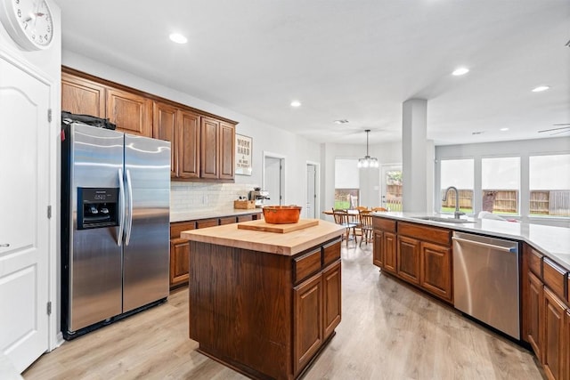 3912 Walsh Ranch Blvd, Round Rock, TX 78681 - kitchen with stainless steel appliances, wood counters, light wood finished floors, backsplash, and recessed lighting