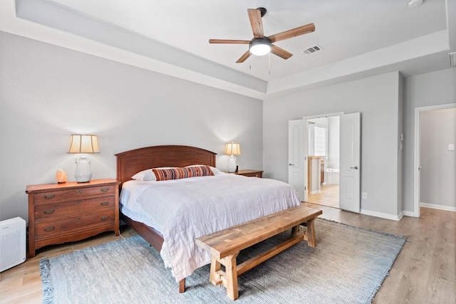 3912 Walsh Ranch Blvd, Round Rock, TX 78681 - bedroom with a raised ceiling, wood finished floors, ensuite bathroom, and ceiling fan