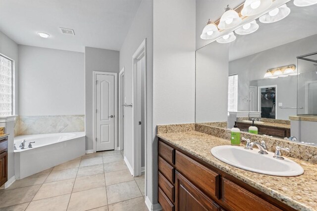 3912 Walsh Ranch Blvd, Round Rock, TX 78681 - full bathroom with vanity, a garden tub, and tile patterned flooring