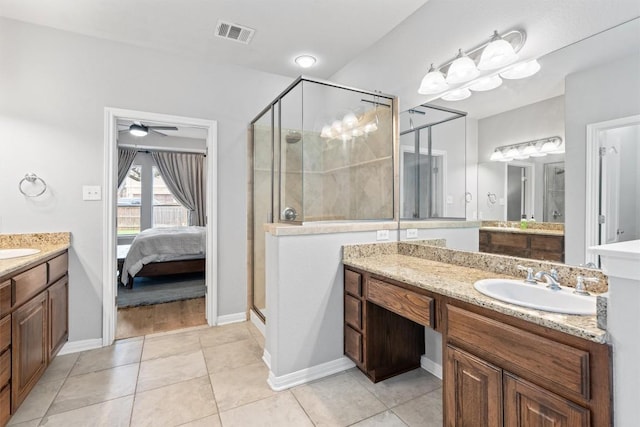 3912 Walsh Ranch Blvd, Round Rock, TX 78681 - bathroom with a stall shower, two vanities, ensuite bathroom, tile patterned floors, and ceiling fan