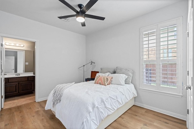 3912 Walsh Ranch Blvd, Round Rock, TX 78681 - bedroom with light wood-style flooring, connected bathroom, and a ceiling fan