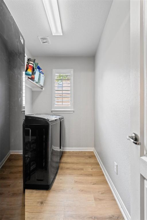 3912 Walsh Ranch Blvd, Round Rock, TX 78681 - laundry area with washing machine and dryer and light wood-type flooring