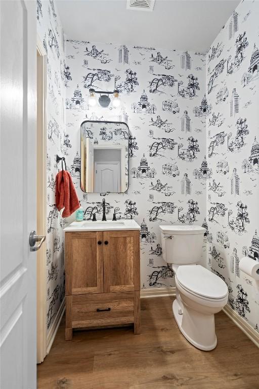 3912 Walsh Ranch Blvd, Round Rock, TX 78681 - half bathroom featuring wallpapered walls, wood finished floors, and vanity
