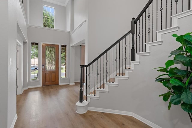 3912 Walsh Ranch Blvd, Round Rock, TX 78681 - entryway with wood finished floors, stairway, a high ceiling, and crown molding
