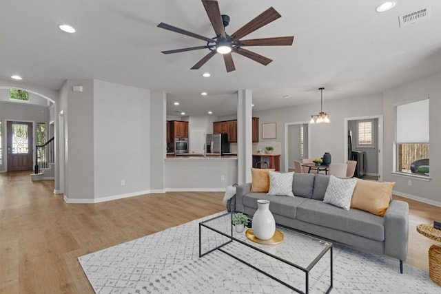 3912 Walsh Ranch Blvd, Round Rock, TX 78681 - living room with plenty of natural light, light wood-type flooring, recessed lighting, ceiling fan, and arched walkways
