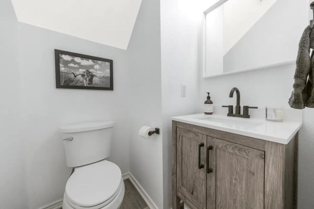 12407 Old Salt Trl, Austin, TX 78732 - half bathroom with vanity, baseboards, toilet, and wood finished floors