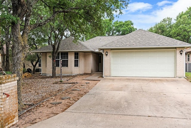 102 Vandeventer Dr, Burnet, TX 78611 - ranch-style house featuring brick siding, driveway, an attached garage, and a shingled roof