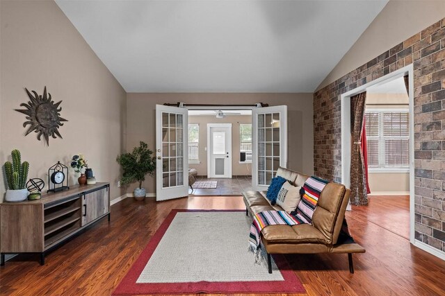 102 Vandeventer Dr, Burnet, TX 78611 - living room with lofted ceiling, french doors, wood finished floors, baseboards, and brick wall