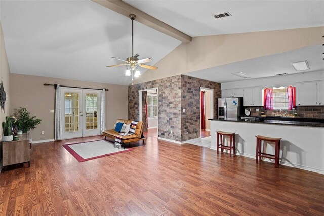 102 Vandeventer Dr, Burnet, TX 78611 - living room featuring healthy amount of natural light, wood finished floors, french doors, a ceiling fan, and high vaulted ceiling