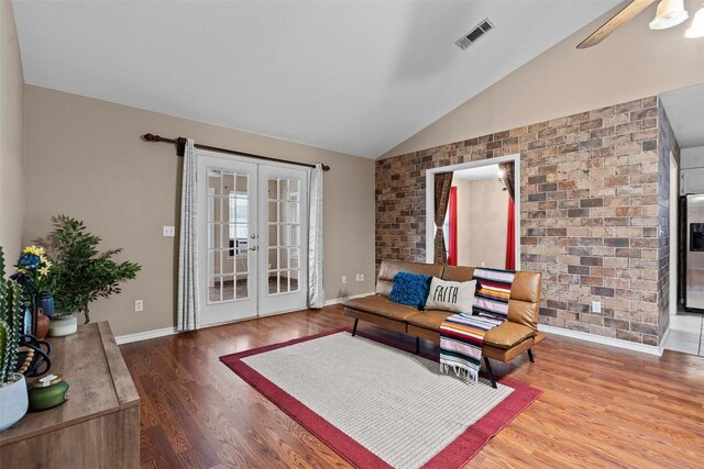 102 Vandeventer Dr, Burnet, TX 78611 - living area featuring lofted ceiling, french doors, wood finished floors, baseboards, and brick wall