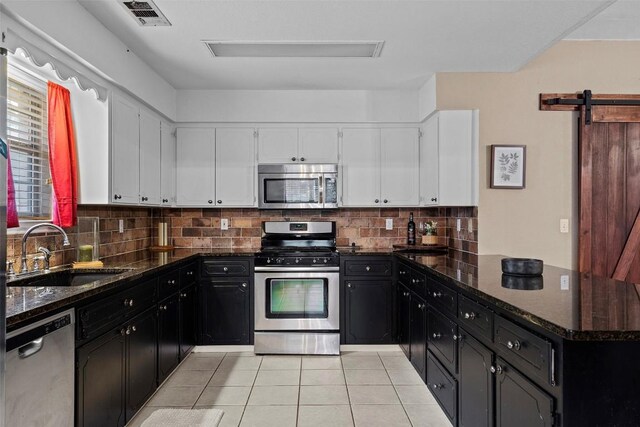 102 Vandeventer Dr, Burnet, TX 78611 - kitchen with appliances with stainless steel finishes, a sink, dark cabinets, and white cabinets