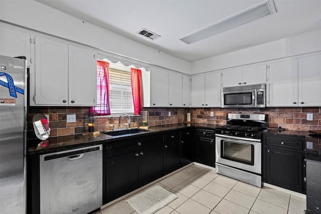 102 Vandeventer Dr, Burnet, TX 78611 - kitchen featuring stainless steel appliances, a sink, white cabinets, and light tile patterned flooring
