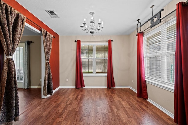 102 Vandeventer Dr, Burnet, TX 78611 - unfurnished dining area featuring a chandelier, wood finished floors, and baseboards