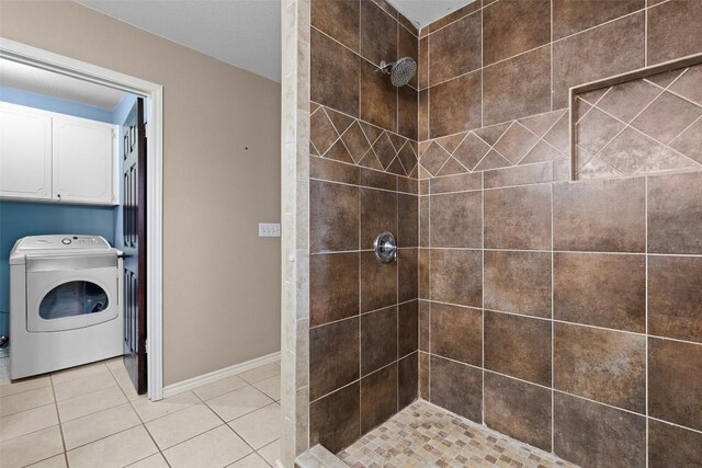 102 Vandeventer Dr, Burnet, TX 78611 - bathroom with washer / clothes dryer, a tile shower, tile patterned floors, and baseboards