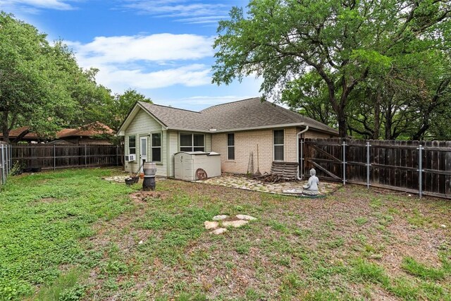102 Vandeventer Dr, Burnet, TX 78611 - back of property with brick siding and roof with shingles
