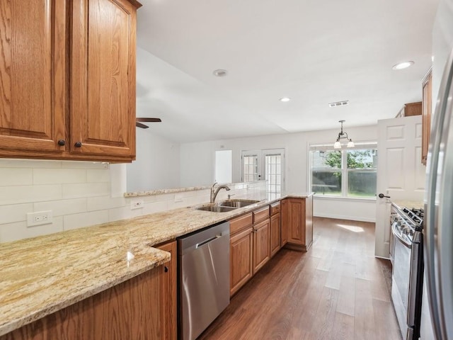11911 Aloe Vera Trl, Austin, TX 78750 - kitchen with appliances with stainless steel finishes, wood finished floors, light stone counters, tasteful backsplash, and ceiling fan