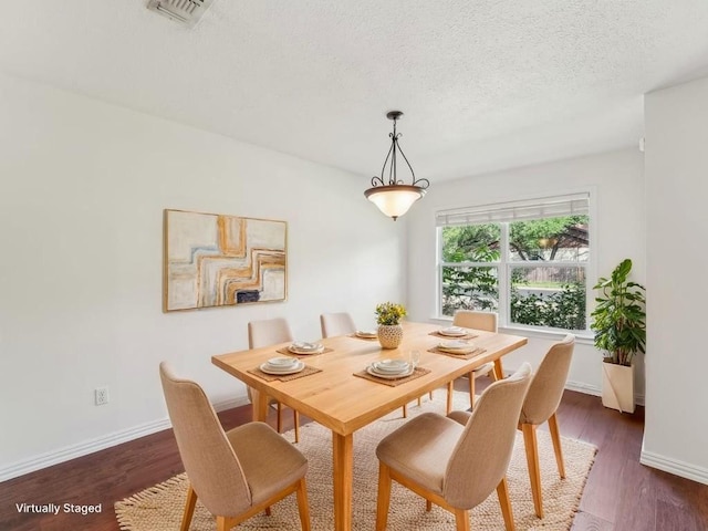 11911 Aloe Vera Trl, Austin, TX 78750 - dining room featuring dark wood finished floors and a textured ceiling