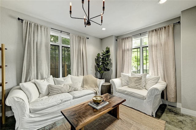 living area featuring baseboards, recessed lighting, a chandelier, and a wealth of natural light