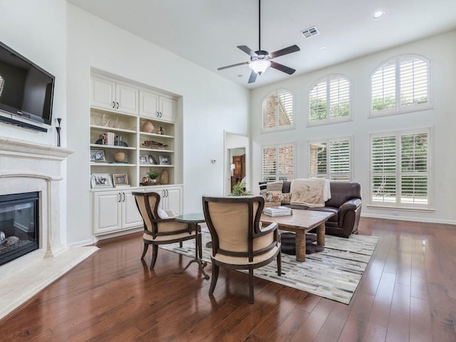 living area with visible vents, ceiling fan, dark wood-type flooring, recessed lighting, and a high end fireplace