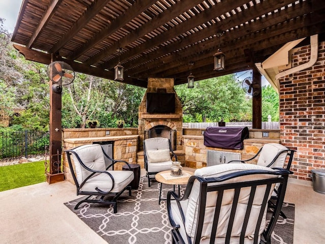 view of patio / terrace with fence, grilling area, and an outdoor stone fireplace