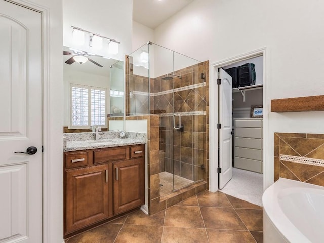 full bath featuring vanity, a garden tub, tile patterned floors, a ceiling fan, and a stall shower