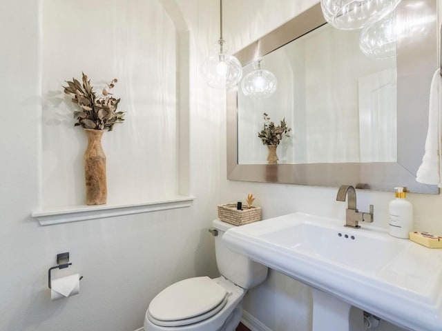 bathroom featuring toilet and a sink