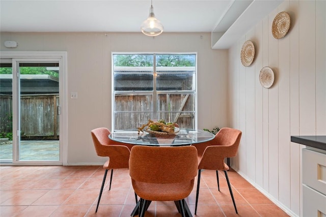 7253 Creekside Dr, Austin, TX 78752 - dining space with baseboards, light tile patterned floors, and a healthy amount of sunlight