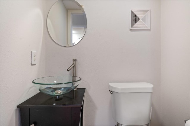 7253 Creekside Dr, Austin, TX 78752 - half bath with vanity, visible vents, and toilet