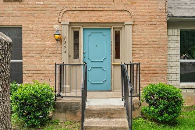7253 Creekside Dr, Austin, TX 78752 - doorway to property with roof with shingles and brick siding