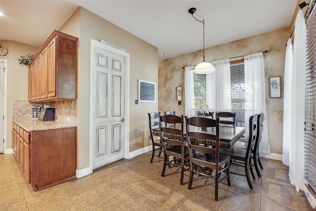 dining space featuring baseboards and light tile patterned floors