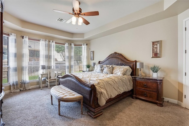 2607 Armatrading Dr, Cedar Park, TX 78613 - bedroom featuring light colored carpet, a tray ceiling, and a ceiling fan